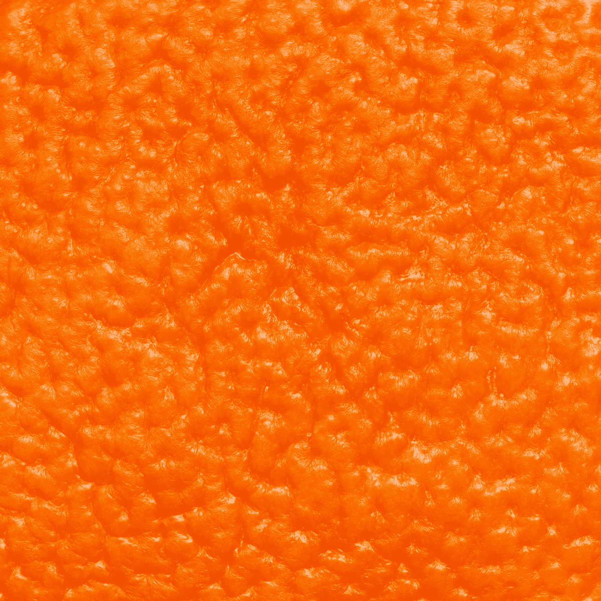 Makroaufnahme der Orangenschale – Ursprung des ätherischen Orangenöls durch Kaltpressung